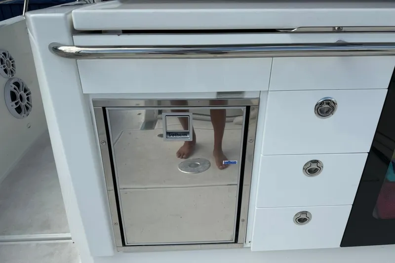 Slide: The Image of 2024 Jeanneau Leader 10.5 CC boat interior with storage and stainless steel features. - 25