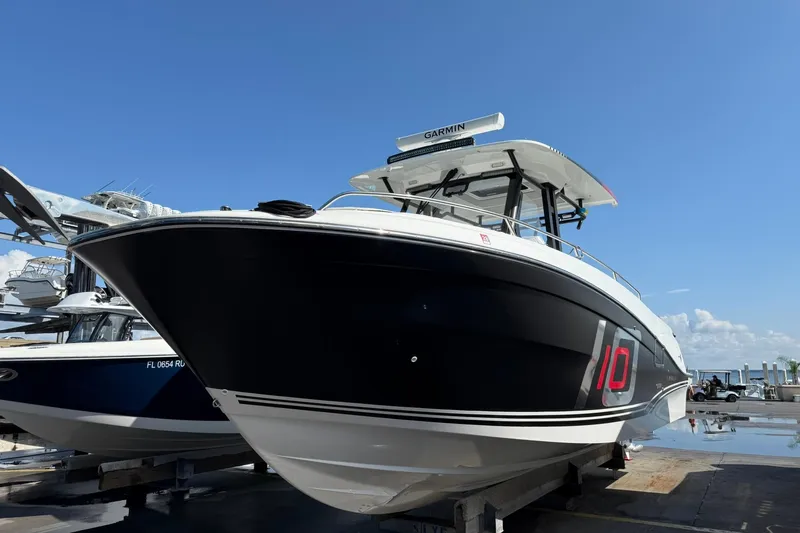 Slide: The Image of 2024 Jeanneau Leader 10.5 CC boat on display under clear blue sky. - 3