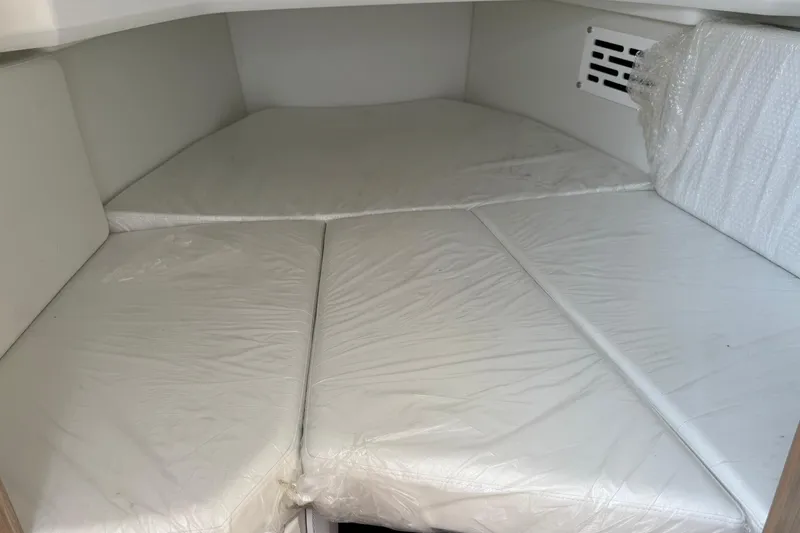 Slide: The Image of 2024 Jeanneau Leader 10.5 CC cabin interior with cushioned sleeping area. - 39