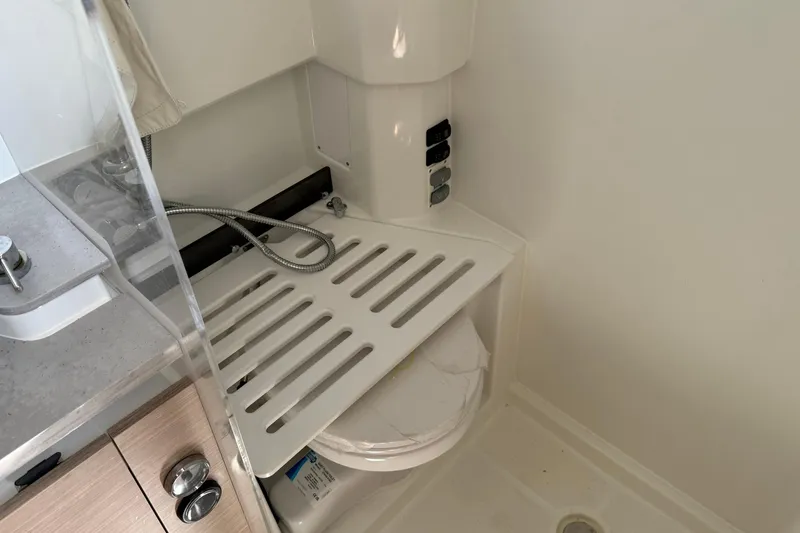 Slide: The Image of 2024 Jeanneau Leader 10.5 CC bathroom with shower and storage area. - 40