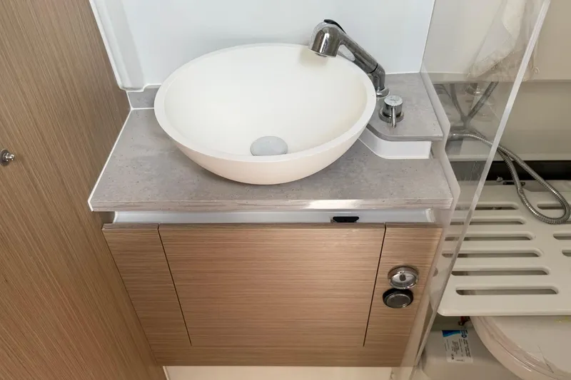 Slide: The Image of 2024 Jeanneau Leader 10.5 CC bathroom sink with modern faucet and wooden cabinetry. - 41