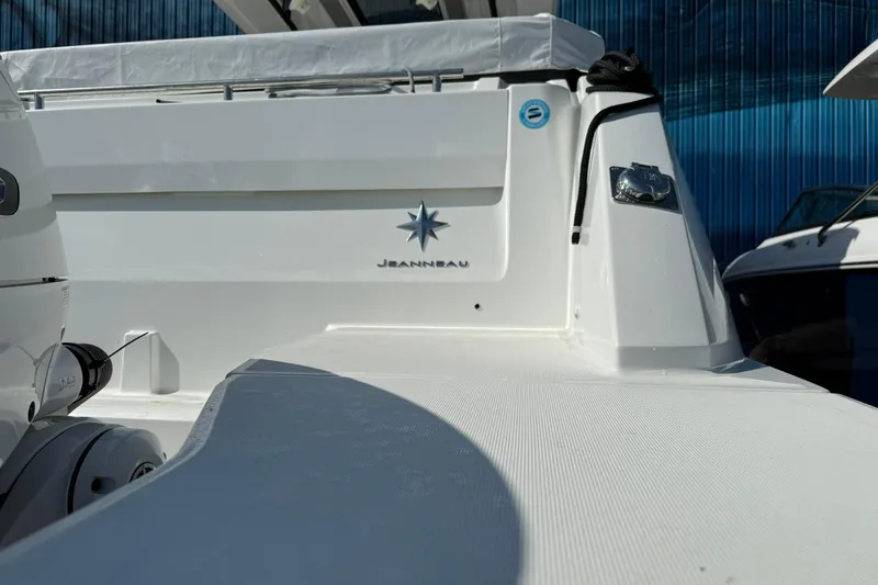 Slide: The Image of 2024 Jeanneau Leader 10.5 CC boat, showcasing sleek white design and branding. - 42