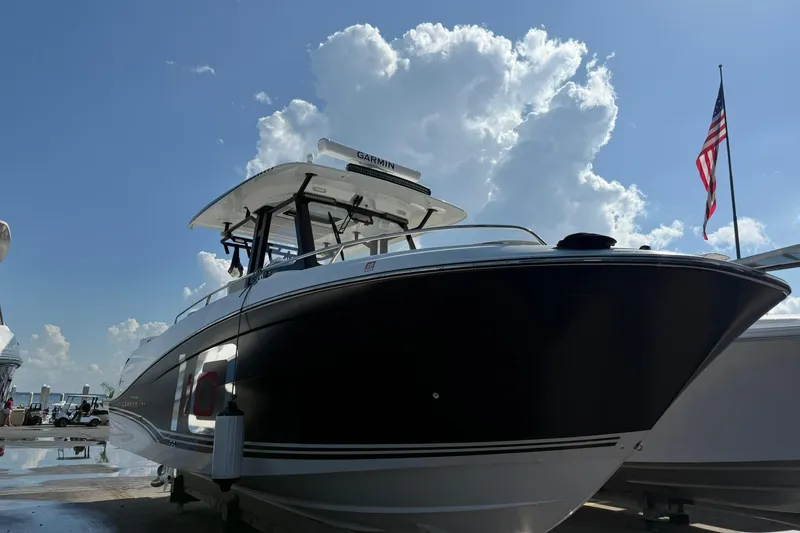 Slide: The Image of 2024 Jeanneau Leader 10.5 CC boat docked under a bright blue sky. - 5