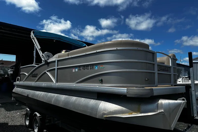 The Image of 2015 Godfrey Sweetwater PE 220 DLX Fish Coastal pontoon boat under a blue sky. - 0