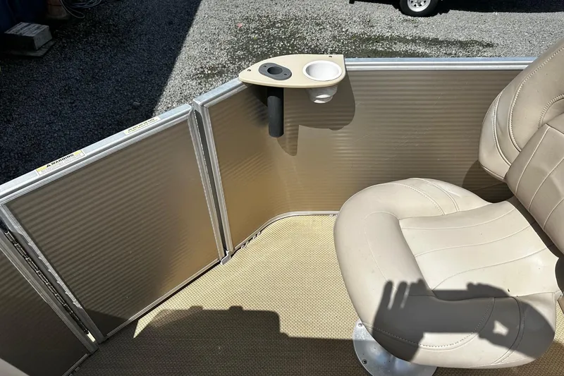 Slide: The Image of 2015 Godfrey Sweetwater PE 220 DLX Fish Coastal boat interior with beige seating and cup holder. - 12