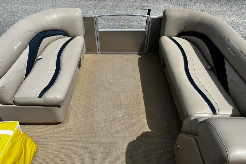 Slide: The Image of Interior of a 2015 Godfrey Sweetwater PE 220 DLX Fish Coastal pontoon boat with beige seating. - 8
