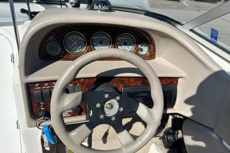 Slide: The Image of Steering wheel and dashboard of 2002 Four Winns 205 Sundowner boat. - 11