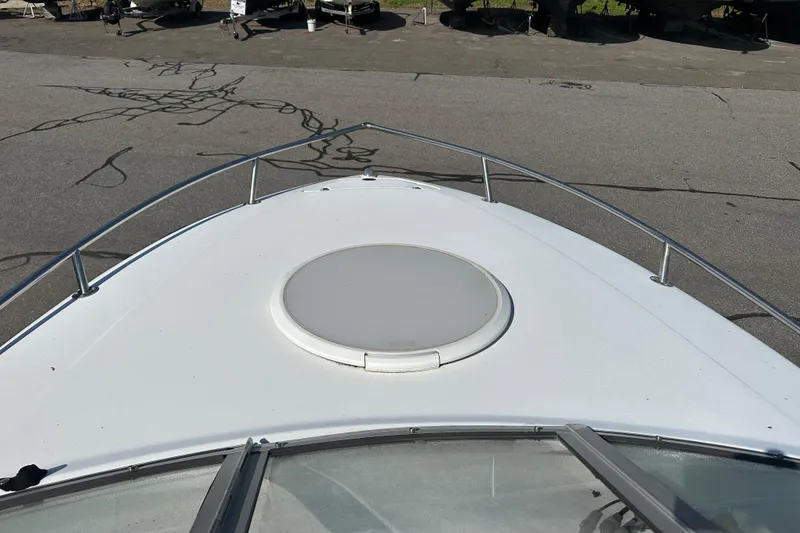 Slide: The Image of 2002 Four Winns 205 Sundowner boat deck with hatch, docked on pavement. - 12
