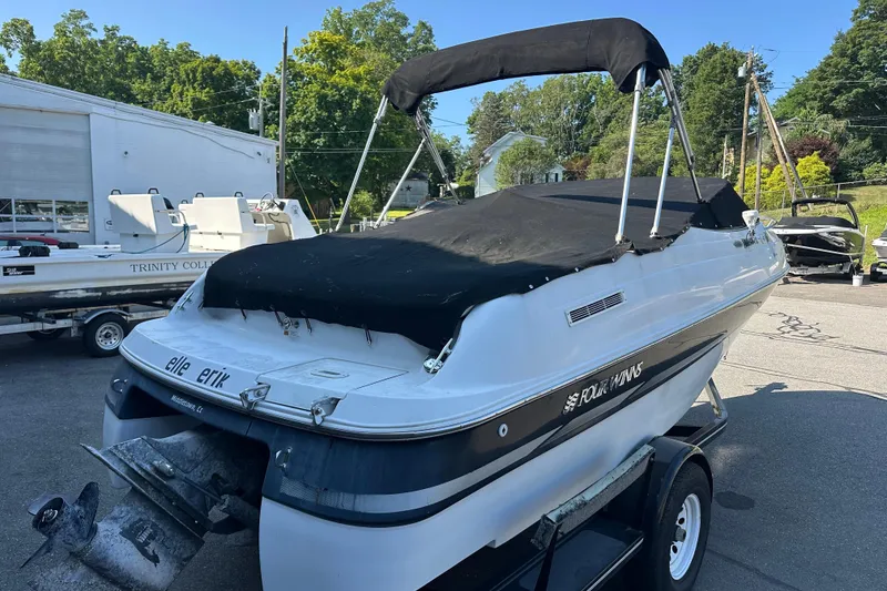 Slide: The Image of 2002 Four Winns 205 Sundowner boat with black cover on trailer. - 15