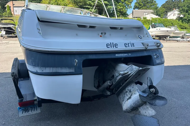 Slide: The Image of 2002 Four Winns 205 Sundowner boat rear view with propeller, parked on a trailer. - 4