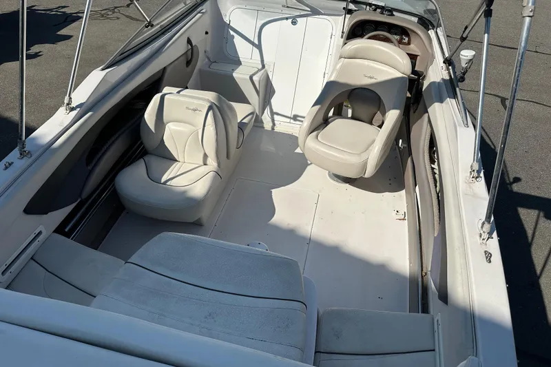 Slide: The Image of 2002 Four Winns 205 Sundowner boat interior with white seating and dashboard. - 5