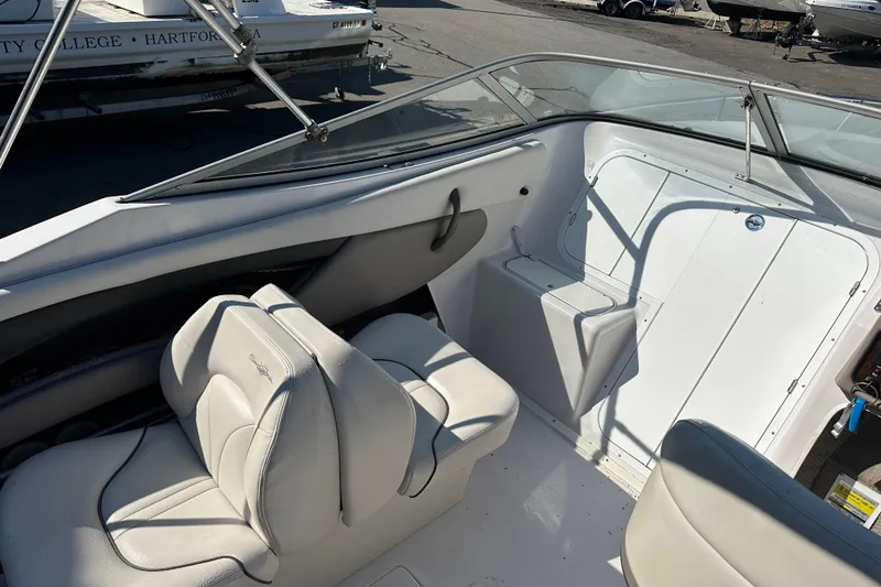 Slide: The Image of 2002 Four Winns 205 Sundowner boat interior with white seating and dashboard. - 9