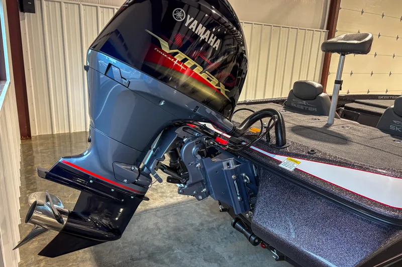 Slide: The Image of 2025 Skeeter ZX150 boat with Yamaha outboard motor in a garage setting. - 10