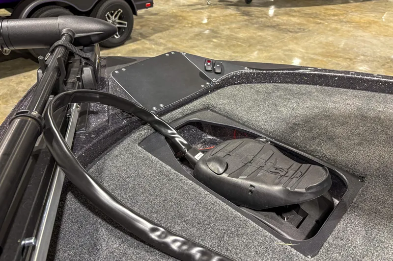 Slide: The Image of 2025 Skeeter ZX150 boat with trolling motor pedal on carpeted deck. - 3