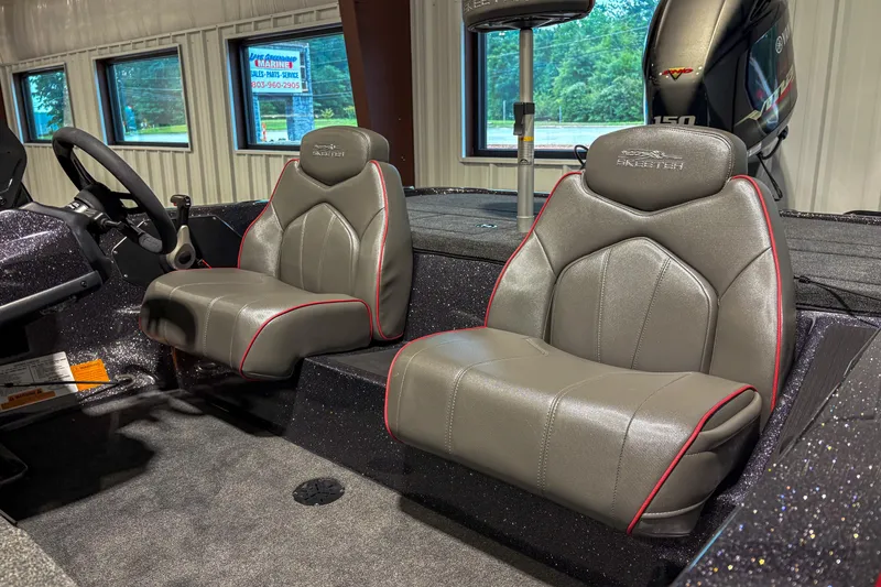 Slide: The Image of 2025 Skeeter ZX150 boat interior with gray seats and red accents. - 5