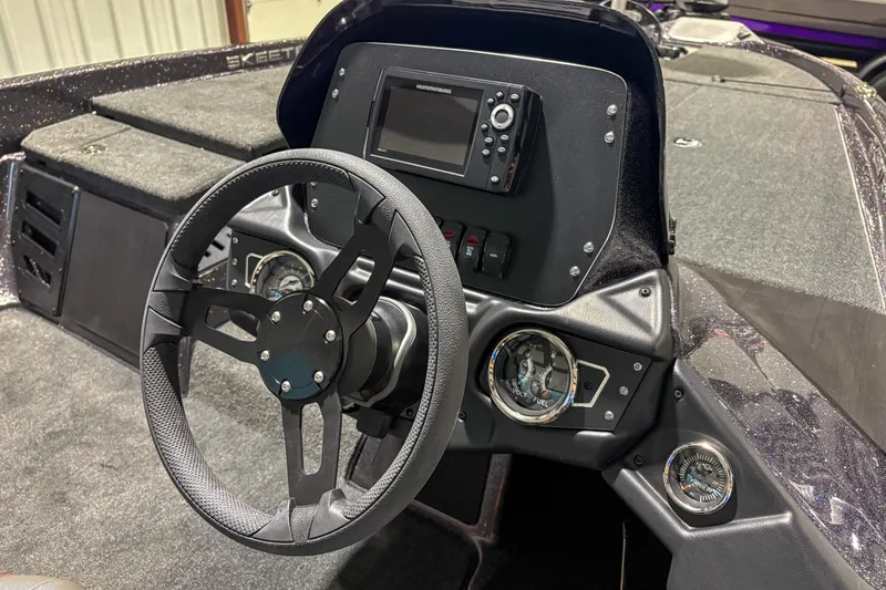 Slide: The Image of 2025 Skeeter ZX150 boat dashboard with steering wheel and electronic display. - 7