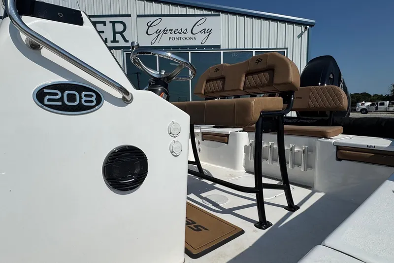 Slide: The Image of 2023 Sea Pro 208 Bay boat interior with tan seating and steering wheel. - 4