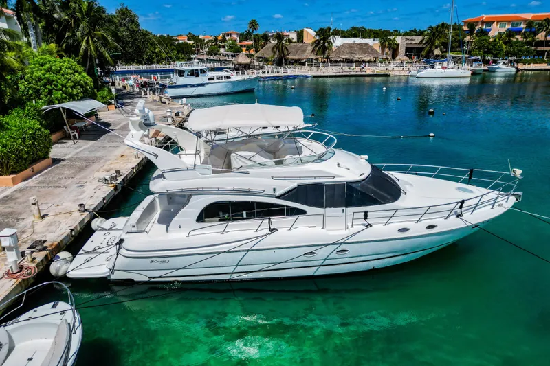 Slide: The Image of 2001 Cruisers Yachts 5000 Sedan Sport docked in a scenic marina. - 0