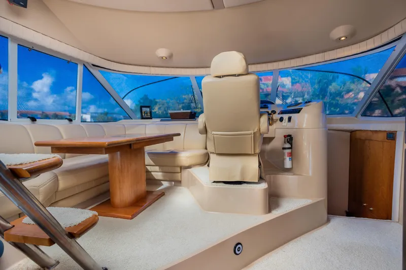 Slide: The Image of Luxurious interior of 2001 Cruisers Yachts 5000 Sedan Sport with helm and seating area. - 10