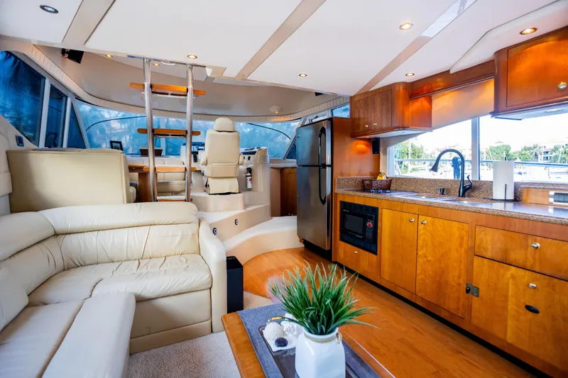Slide: The Image of Luxurious interior of 2001 Cruisers Yachts 5000 Sedan Sport with modern kitchen and seating area. - 15