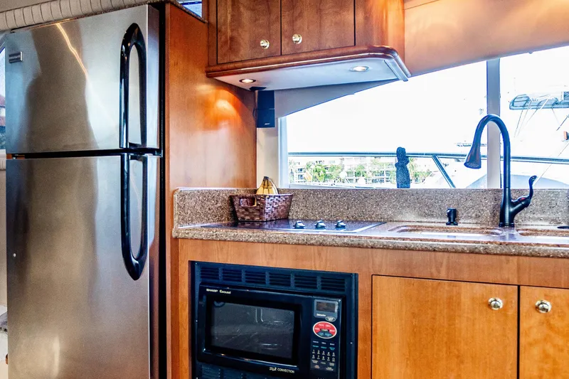 Slide: The Image of Luxurious kitchen interior of 2001 Cruisers Yachts 5000 Sedan Sport with modern appliances. - 19