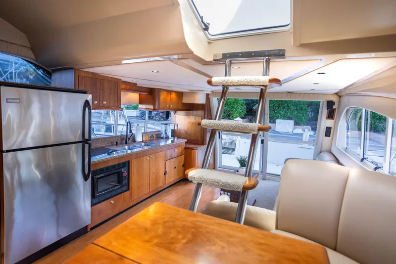 Slide: The Image of Luxurious interior of 2001 Cruisers Yachts 5000 Sedan Sport with modern kitchen amenities. - 23