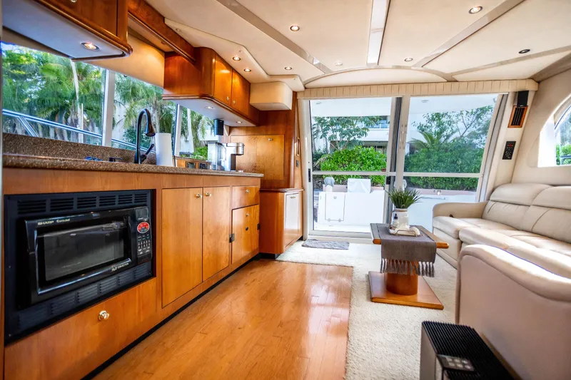 Slide: The Image of Luxurious interior of 2001 Cruisers Yachts 5000 Sedan Sport with modern kitchen and seating area. - 24