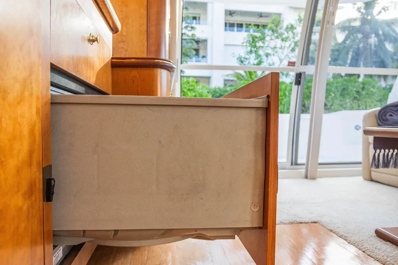 Slide: The Image of Open drawer in 2001 Cruisers Yachts 5000 Sedan Sport interior, with wooden cabinetry and window view. - 25