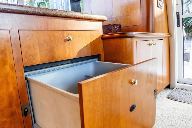Slide: The Image of Wooden cabinetry with open drawer in 2001 Cruisers Yachts 5000 Sedan Sport interior. - 26