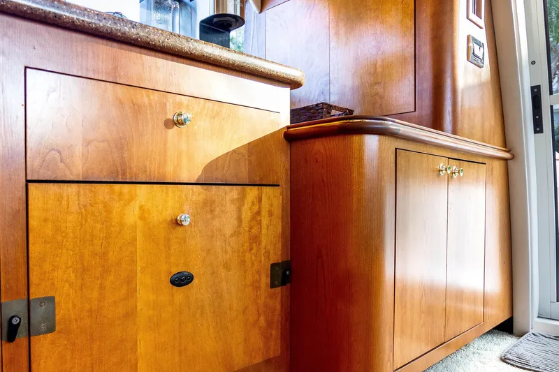 Slide: The Image of Interior of 2001 Cruisers Yachts 5000 Sedan Sport with polished wooden cabinetry. - 27