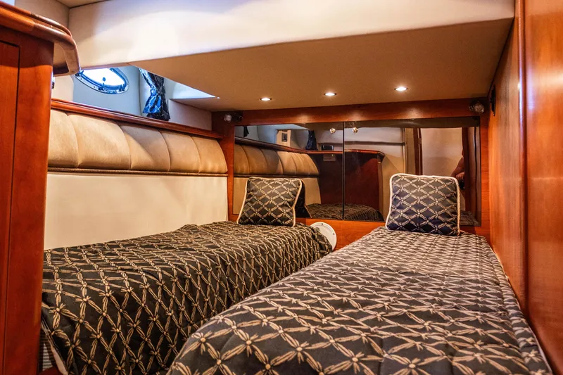 Slide: The Image of Interior cabin of 2001 Cruisers Yachts 5000 Sedan Sport with twin beds and elegant decor. - 28