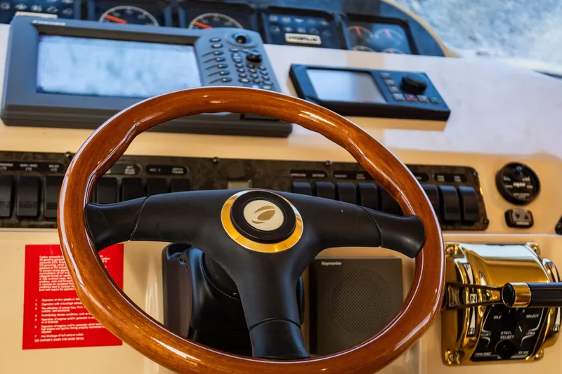 Slide: The Image of Steering wheel and controls of 2001 Cruisers Yachts 5000 Sedan Sport. - 3