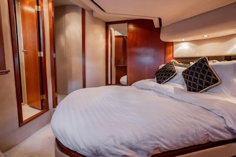Slide: The Image of Luxurious bedroom interior of 2001 Cruisers Yachts 5000 Sedan Sport with elegant wood finishes. - 30