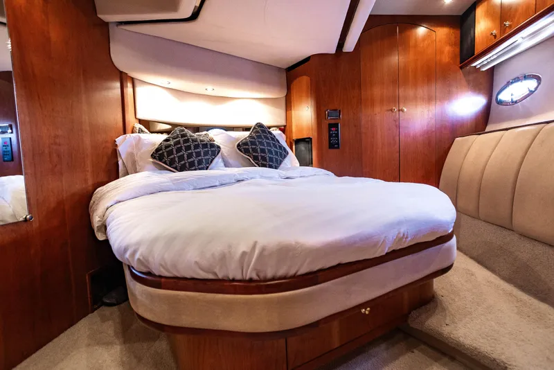 Slide: The Image of Luxurious bedroom interior of 2001 Cruisers Yachts 5000 Sedan Sport with elegant wood finish. - 31
