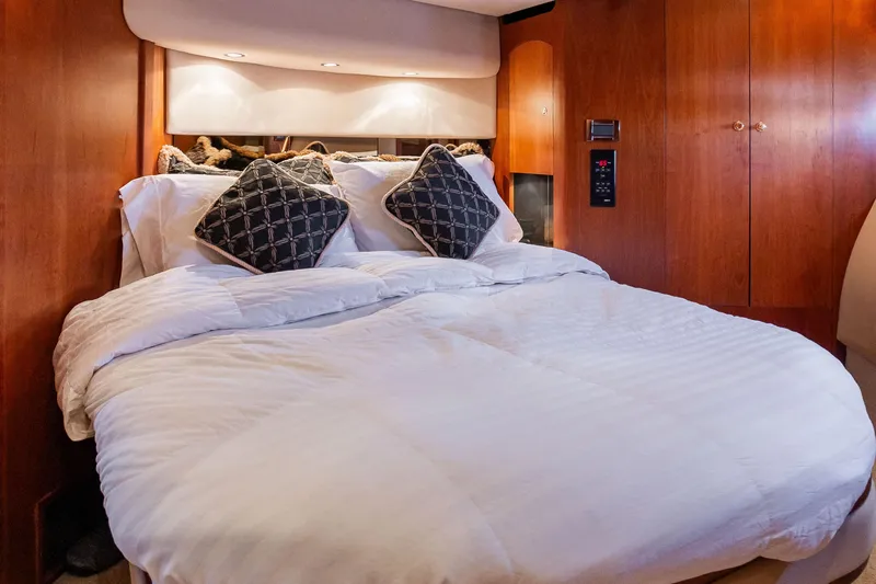 Slide: The Image of Luxurious bedroom interior of 2001 Cruisers Yachts 5000 Sedan Sport with plush bedding. - 32