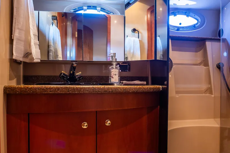 Slide: The Image of Luxurious bathroom in 2001 Cruisers Yachts 5000 Sedan Sport with elegant wood cabinetry. - 35