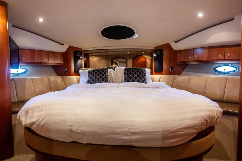 Slide: The Image of Luxurious bedroom interior of 2001 Cruisers Yachts 5000 Sedan Sport with elegant wood finish. - 36