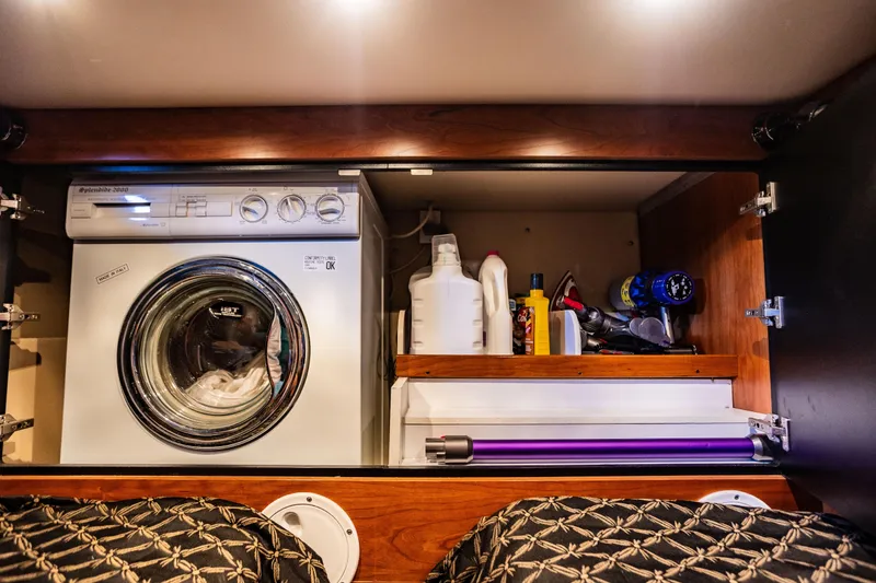 Slide: The Image of Laundry area in 2001 Cruisers Yachts 5000 Sedan Sport with washer and storage shelves. - 38