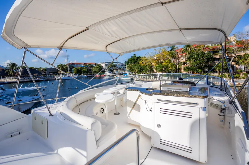 Slide: The Image of 2001 Cruisers Yachts 5000 Sedan Sport, spacious deck with seating, docked in marina. - 39