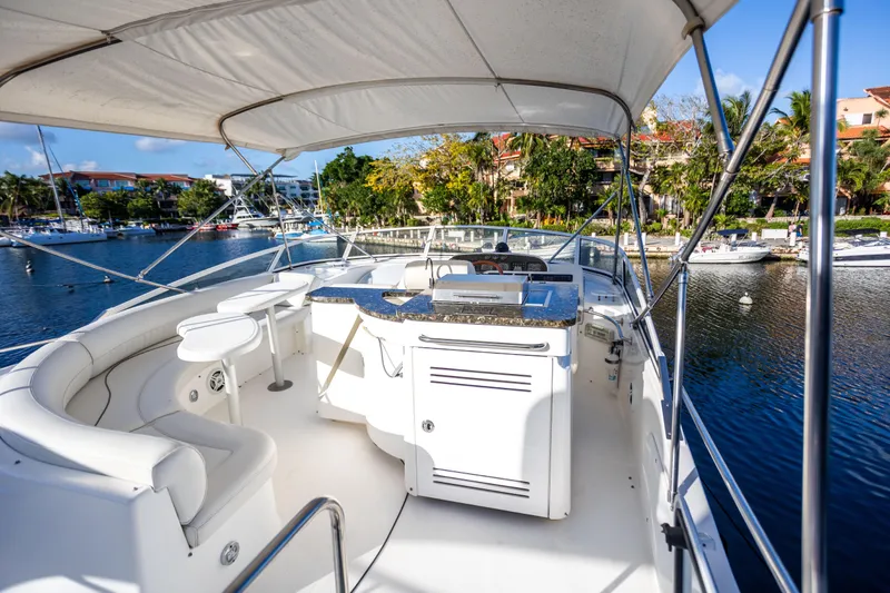 Slide: The Image of 2001 Cruisers Yachts 5000 Sedan Sport, luxurious deck view, marina backdrop. - 41