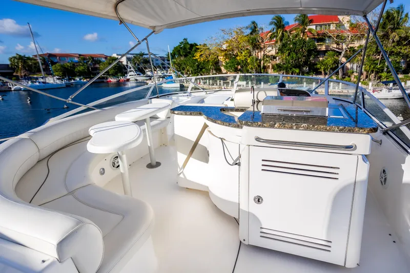 Slide: The Image of Luxurious 2001 Cruisers Yachts 5000 Sedan Sport with elegant seating and outdoor kitchen. - 43