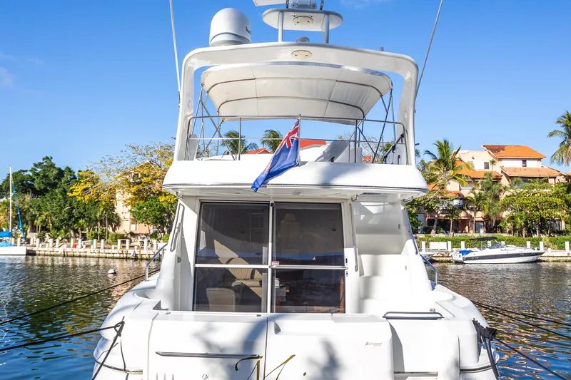 Slide: The Image of 2001 Cruisers Yachts 5000 Sedan Sport docked in sunny marina setting. - 56