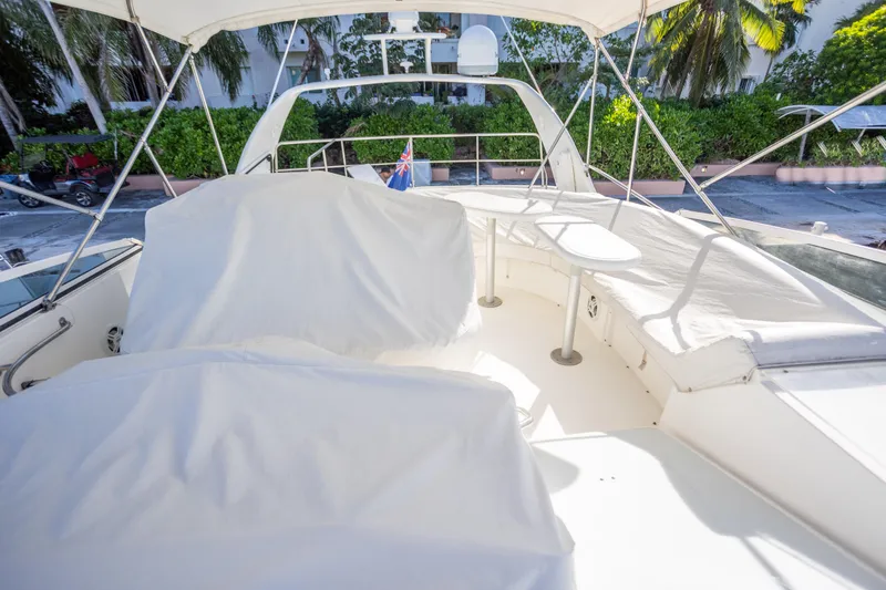 Slide: The Image of 2001 Cruisers Yachts 5000 Sedan Sport flybridge with covered seating and table. - 57