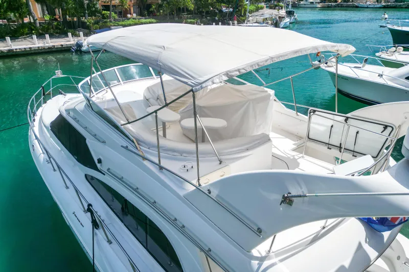 Slide: The Image of 2001 Cruisers Yachts 5000 Sedan Sport docked in a serene marina setting. - 68