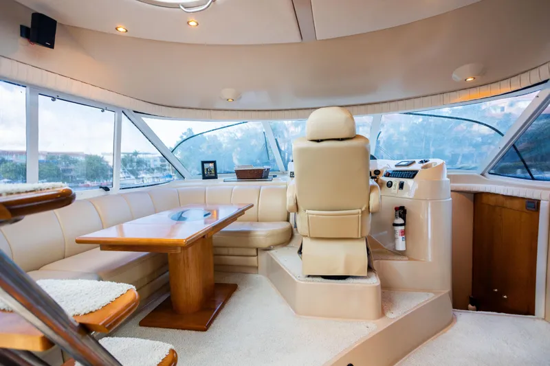 Slide: The Image of Luxurious interior of 2001 Cruisers Yachts 5000 Sedan Sport with helm and seating area. - 7