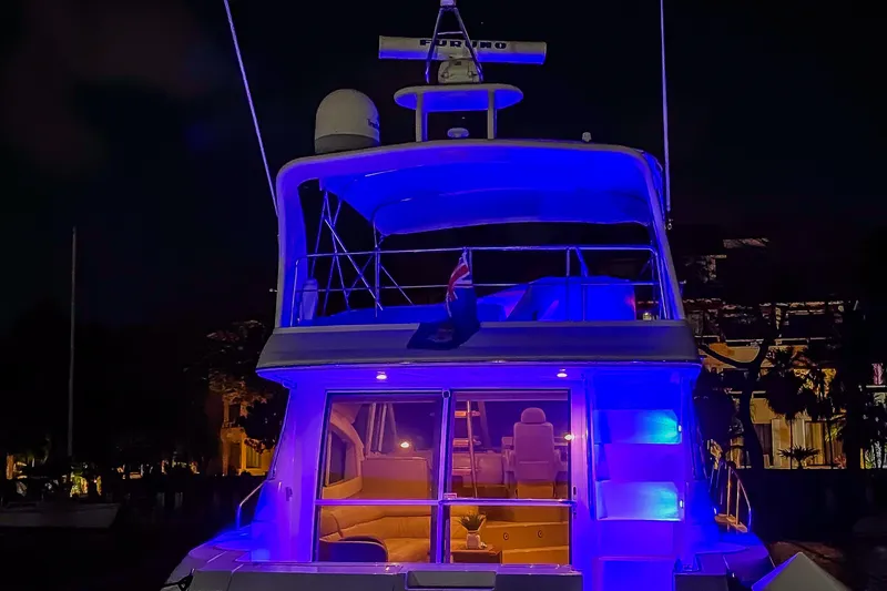 Slide: The Image of 2001 Cruisers Yachts 5000 Sedan Sport illuminated at night with blue lights. - 74