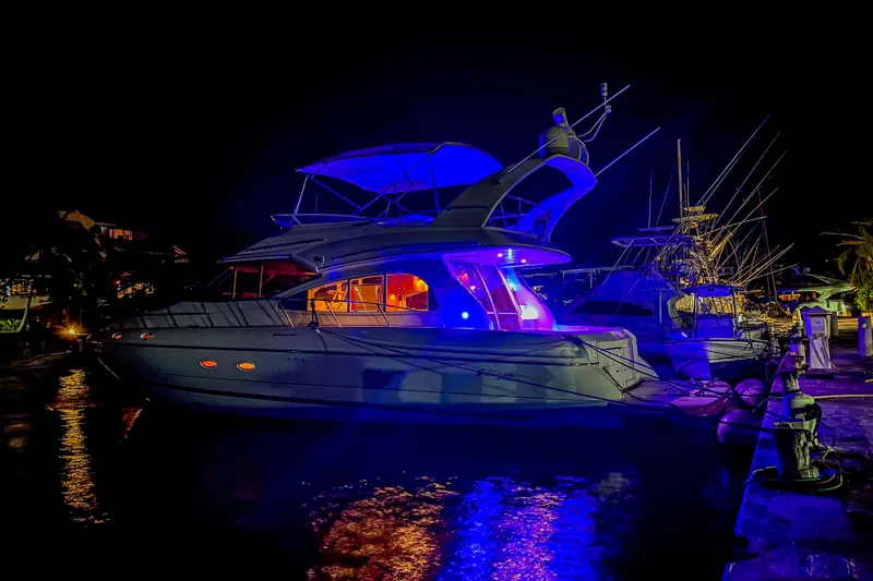 Slide: The Image of 2001 Cruisers Yachts 5000 Sedan Sport illuminated at night in marina. - 76