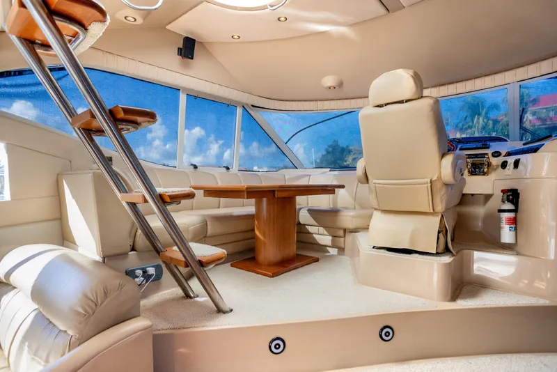 Slide: The Image of Luxurious interior of 2001 Cruisers Yachts 5000 Sedan Sport with plush seating and helm. - 8