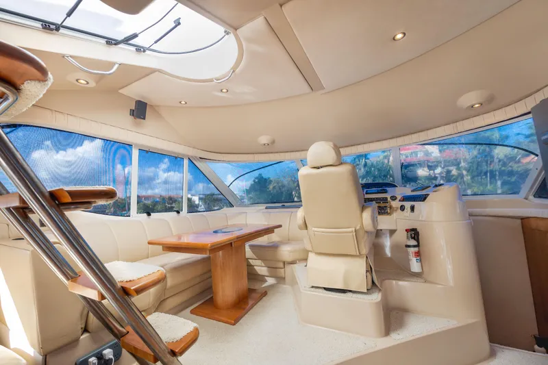 Slide: The Image of Luxurious interior of 2001 Cruisers Yachts 5000 Sedan Sport with panoramic windows and plush seating. - 9