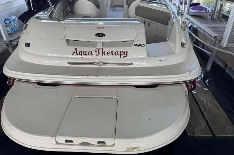 Slide: The Image of 2006 Sea Ray 240 Sundeck boat named "Aqua Therapy" docked at marina. - 13